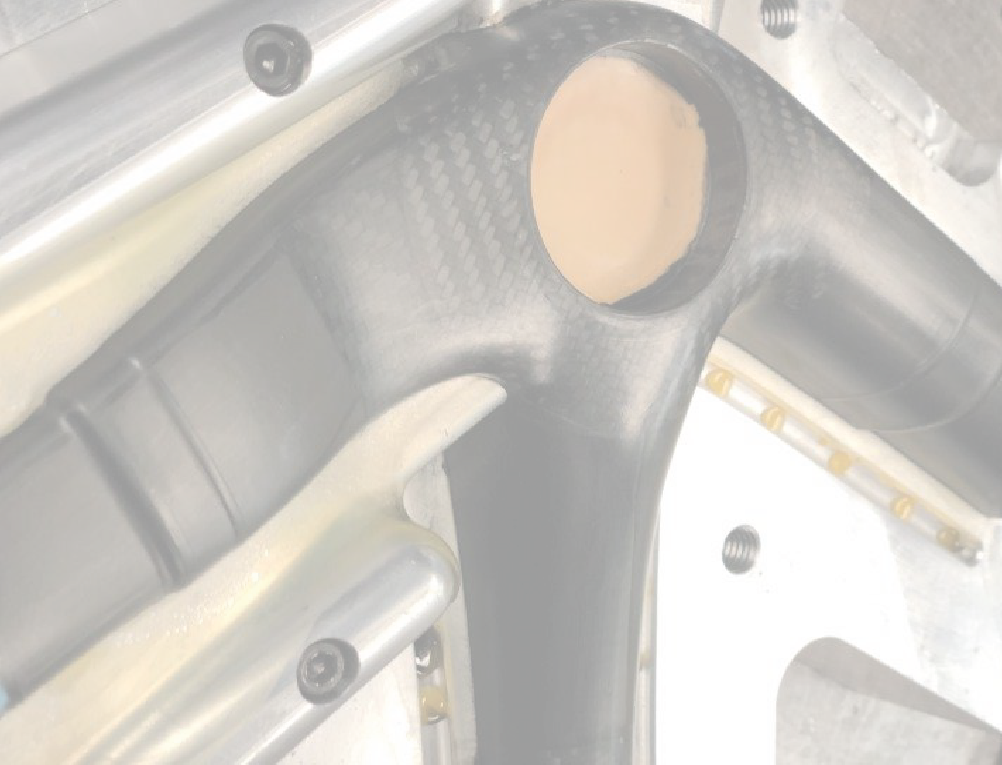 Carbon fiber bike frame in metal mold during manufacturing process.