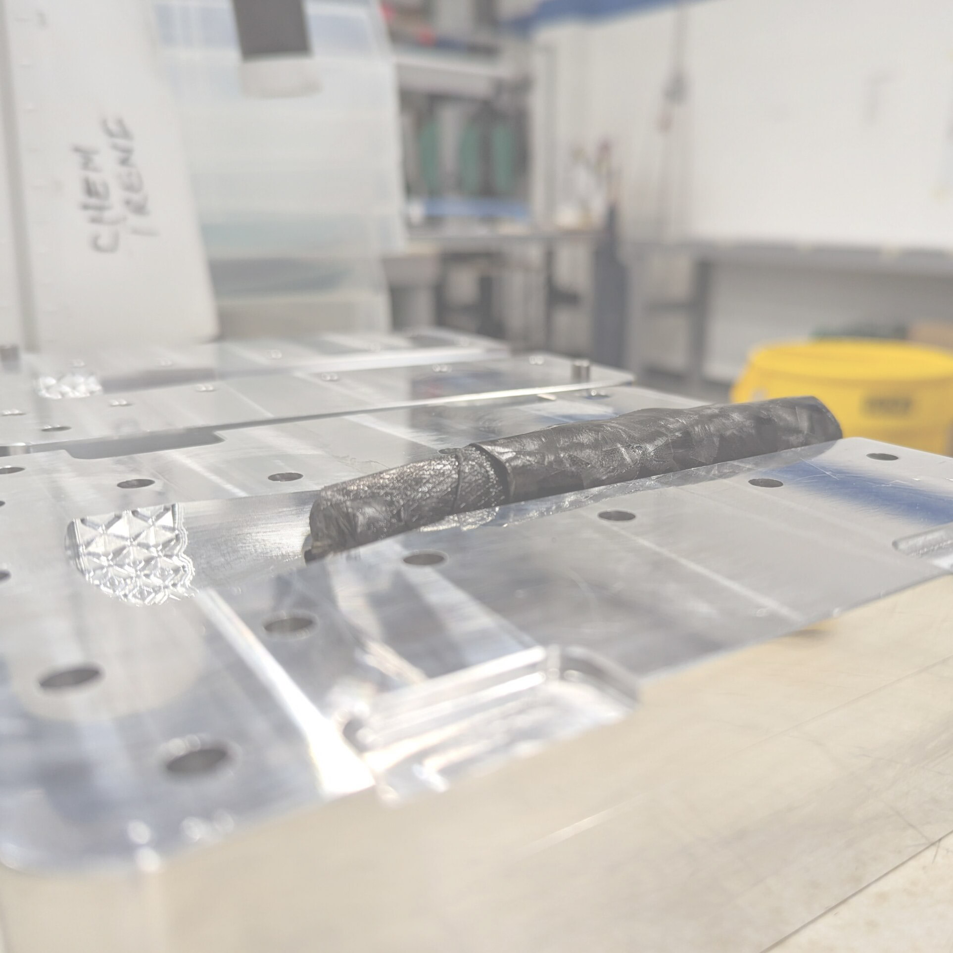Rolled carbon fiber in steel mold.