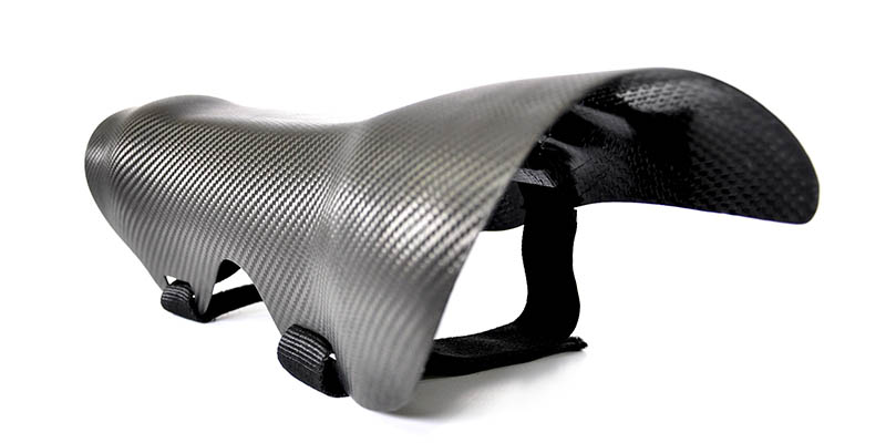 Compression molded custom leg brace made of carbon fiber.